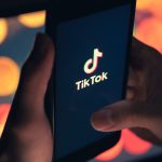 Tik Tok application icon on iPhone 11 pro max screen in hand and have a bokeh for background. Tiktok social media network.May 7, 2021, Bangkok, Thailand