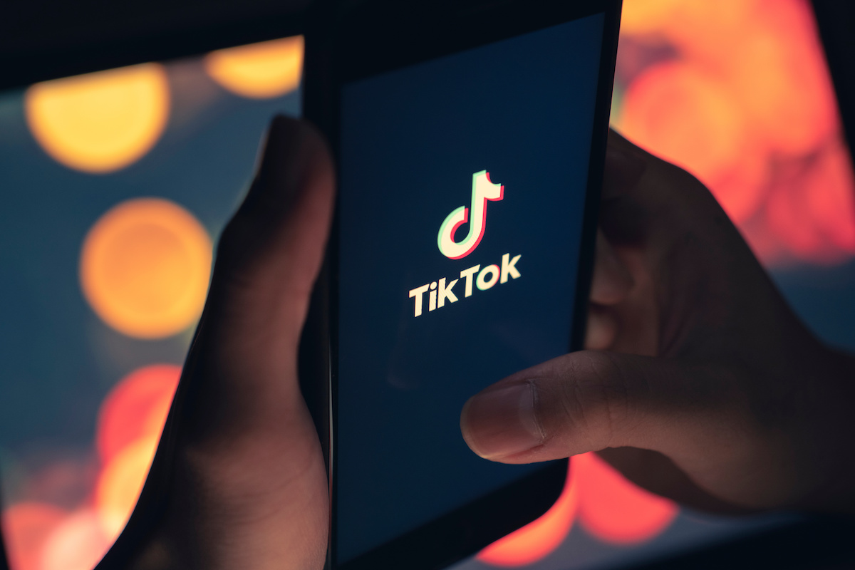 Tik Tok application icon on iPhone 11 pro max screen in hand and have a bokeh for background. Tiktok social media network.May 7, 2021, Bangkok, Thailand